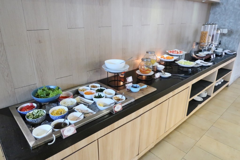 Buffet breakfast spread of salads, fruits and cereal at Swiss-Belinn Legian Hotel