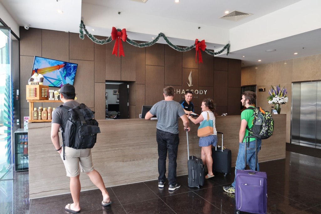 Rhapsody Resort's lobby reception area with guests lining up