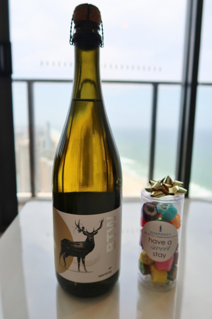 Bottle of wine and container of hard sweets amenities from Rhapsody Resort