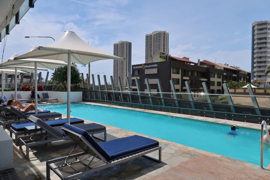 Rhapsody Resort's pool with poolside lounge chairs and cabanas
