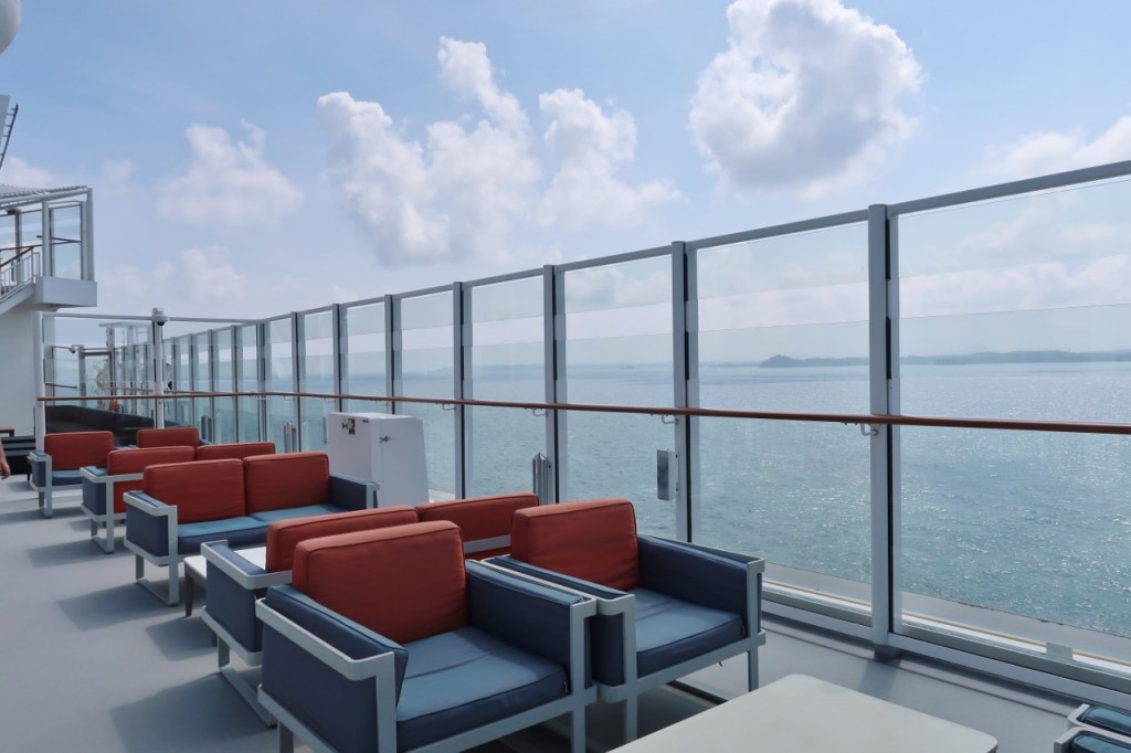 Comfy deck chairs and a view of the sea on Genting Dream Cruises