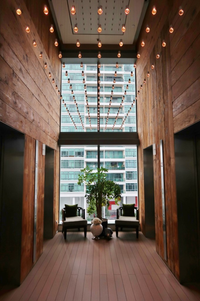 Club lounge lift lobby with fairy lights above at Oasia Hotel Novena