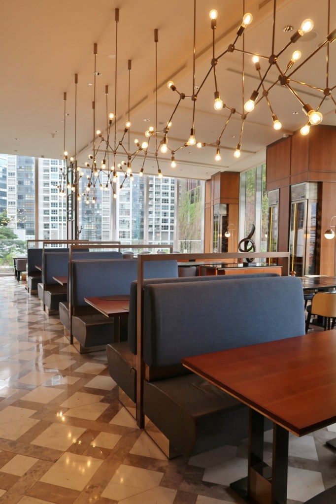 Dining area with warm lighting at Racines at Sofitel Singapore City Centre hotel