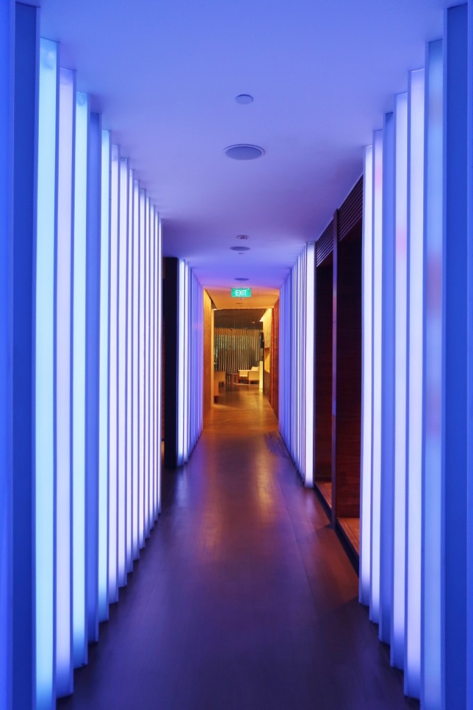 Neon-blue lit corridor at Damai Spa & Fitness Centre at Grand Hyatt hotel
