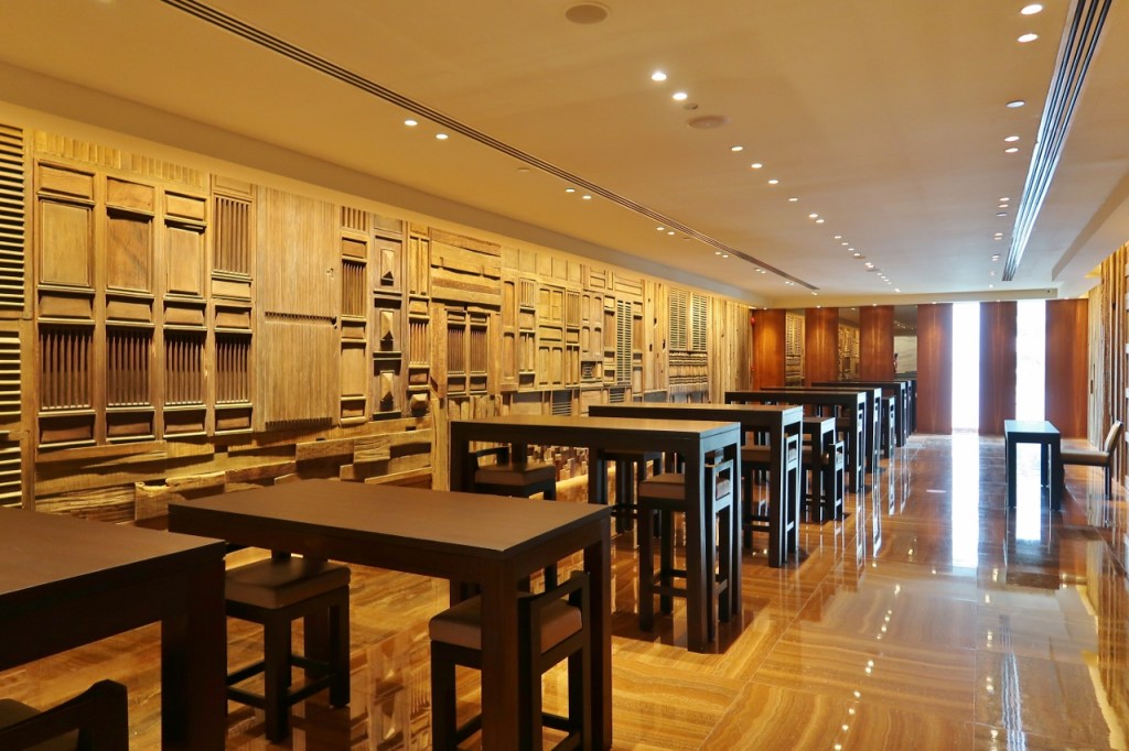 Wide corridor with wooden high tables and chairs at Grand Hyatt hotel