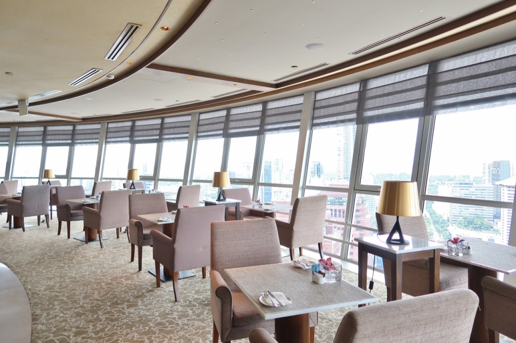 Dining area at Top Of The M Meritus Club Lounge in the day at Mandarin Orchard Hotel
