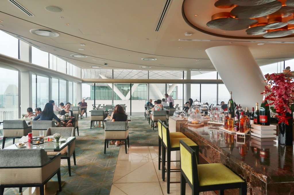 Guests having afternoon tea at Club55, Marina Bay Sands Hotel's club lounge