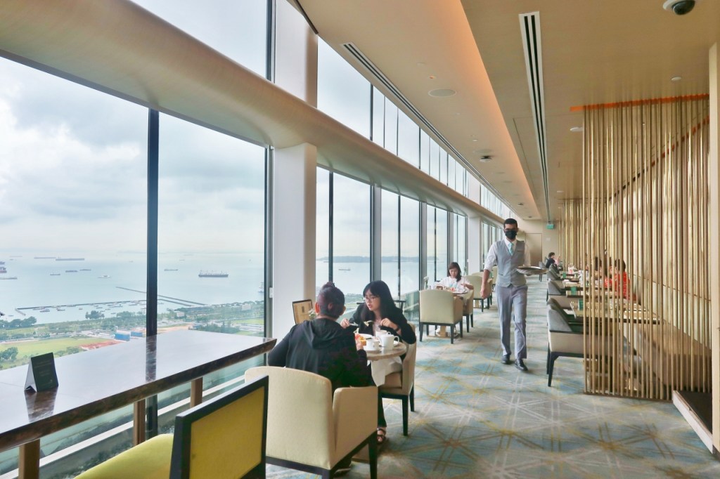Guests having afternoon tea at Club55, Marina Bay Sands Hotel's club lounge