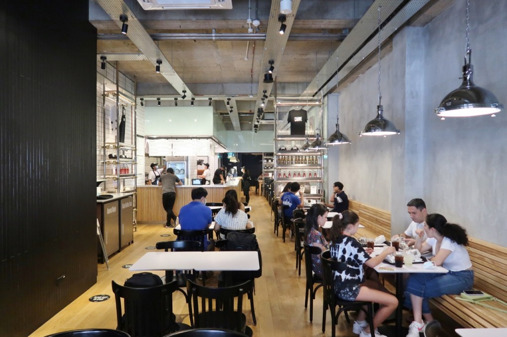 Seating area with industrial aesthetic at CARNE Burgers restaurant