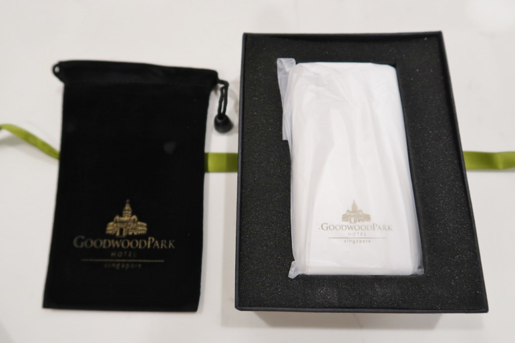 A slim power bank with a Goodwood Park Hotel logo on it