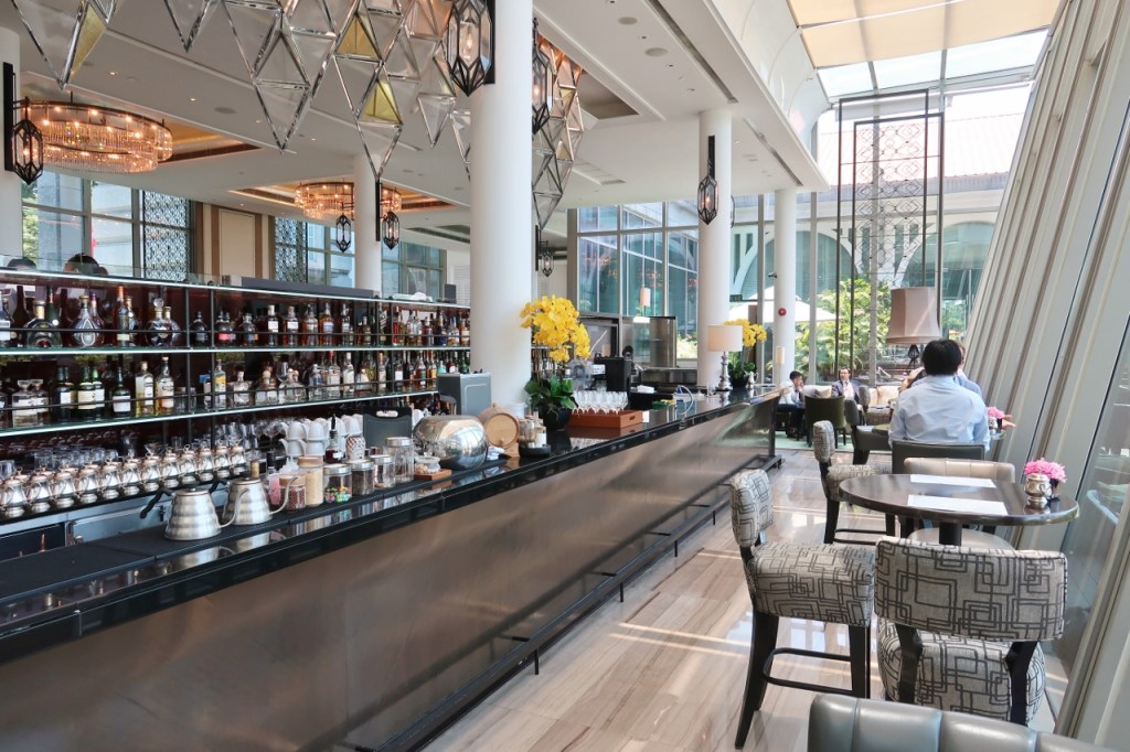 Seating and bar area at The Landing Point restaurant at The Fullerton Bay Hotel