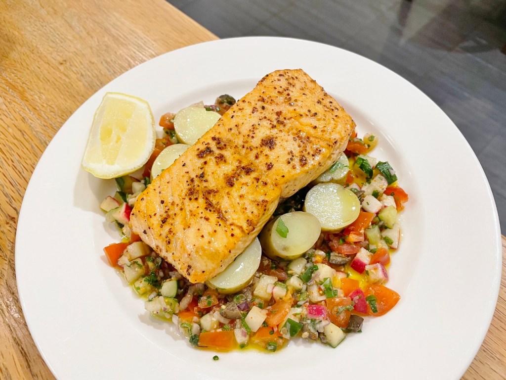 Pan-seared Scottish salmon on vegetables from Saveur restaurant