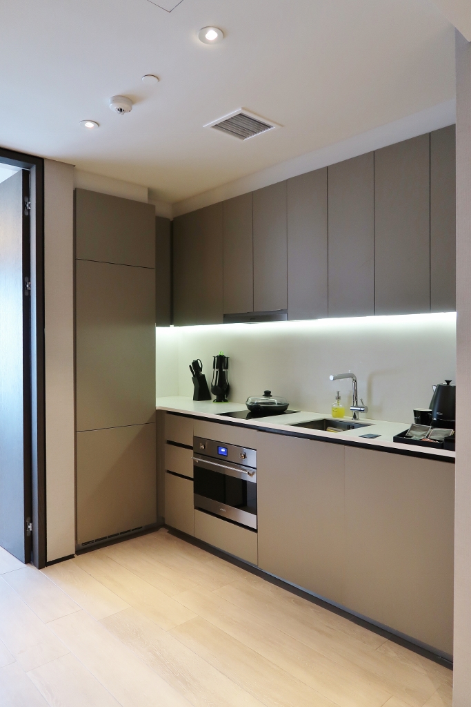 Kitchen in One-Bedroom Deluxe Apartment at Oakwood Premier AMTD Hotel & Serviced Apartments