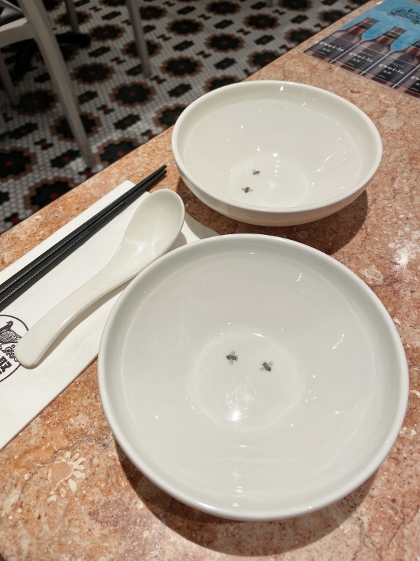 Bowls with printed images of houseflies at Social Place restaurant