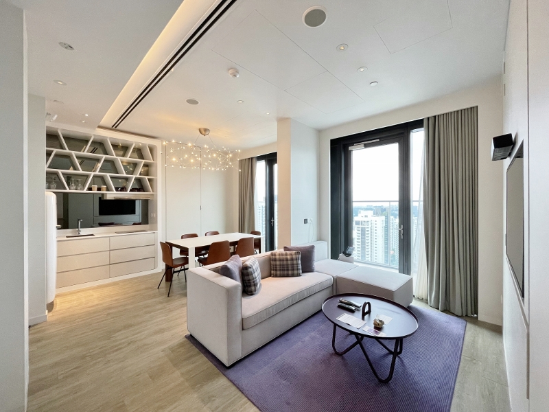 Living and dining room in VIP King Suite View at YOTEL Orchard Hotel