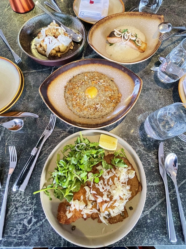 Iberico pork schnitzel, truffle rice porridge, baked cauliflower and Norwegian salmon dishes from CÉ LA VI Restaurant & SkyBar at Marina Bay Sands Hotel