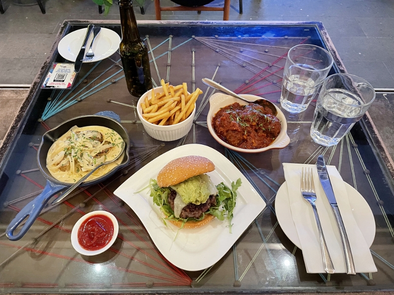 The Sabio burger, sea scallops with white wine sauce and beef meatballs in spicy tomato sauce from Sabio By The Sea Tapas Bar & Grill restaurant