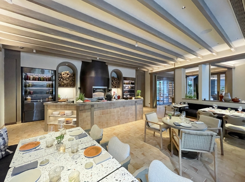 Indoor seating area at Fiamma restaurant at Capella Hotel