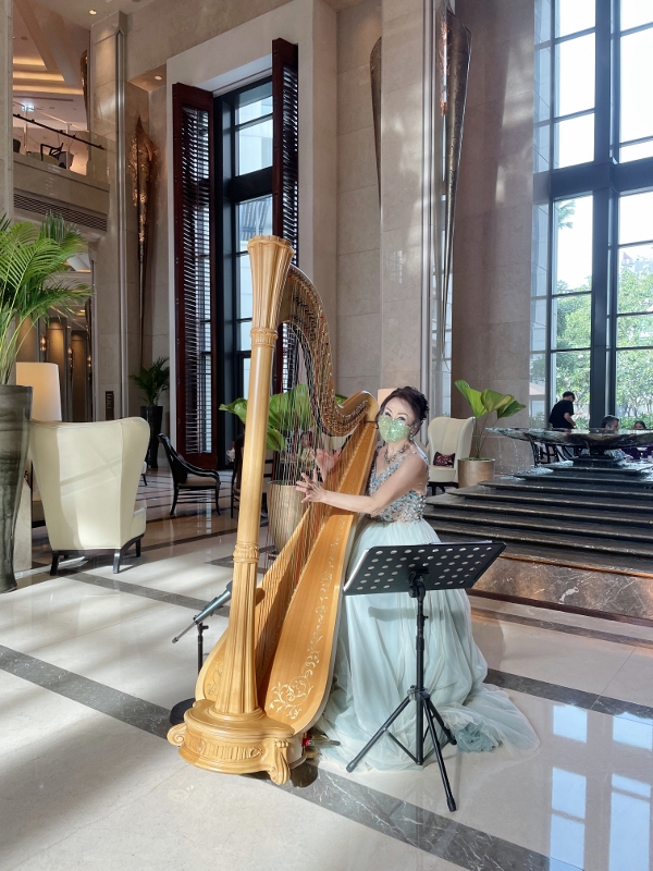 Harpist performing at the lobby of Siam Kempinski Hotel