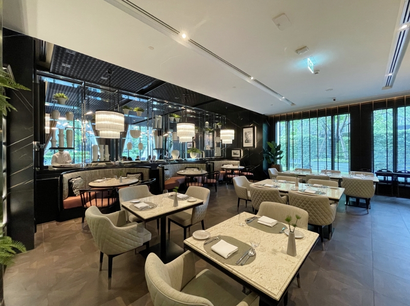 Seating area at Flourish restaurant at Sindhorn Kempinski Hotel