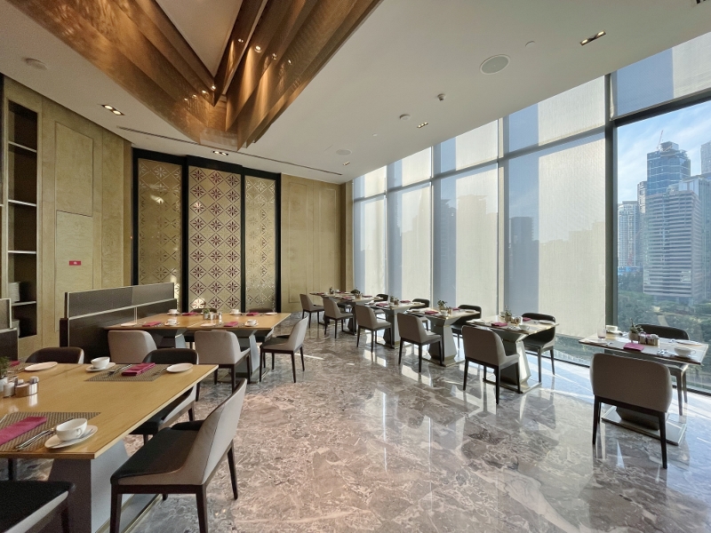 Seating area at Curate restaurant at Four Seasons Hotel Kuala Lumpur