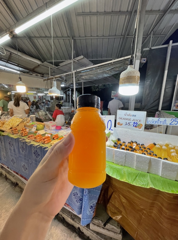 A bottle of orange juice at Naka Weekend Market