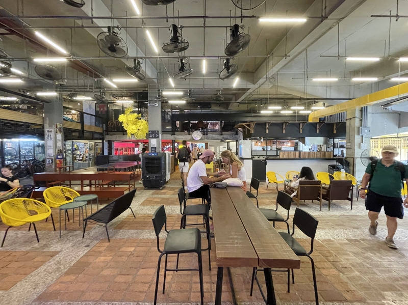 Seating area at The Background food hall at REXKL Arts & Culture Hub