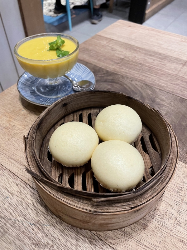 Signature egg custard buns and mango pomelo dessert at Dolly Dim Sum restaurant at NU Sentral shopping mall
