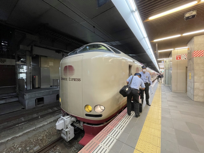 Sunrise Express sleeper train conductors changing shifts at Osaka station