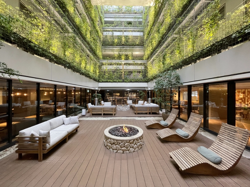 Outdoor seating and courtyard green wall at Good Nature Hotel Kyoto