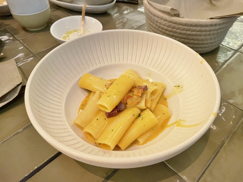 Creamy rigatoni with crispy pork belly and egg yolk from Noa Lounge